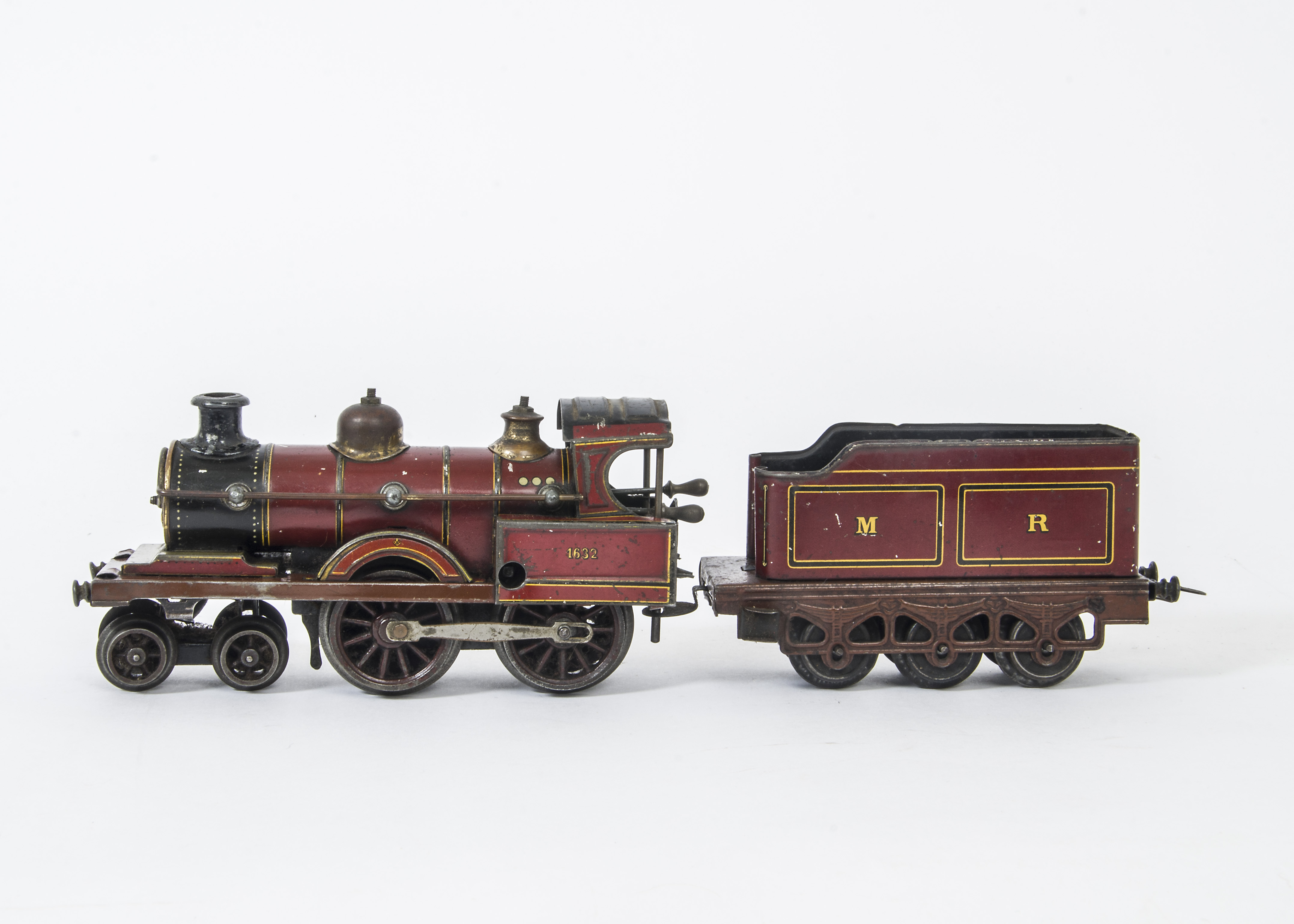 An Uncommon and Early Carette O Gauge Clockwork '4-4-0' Locomotive and Tender, actually a single-