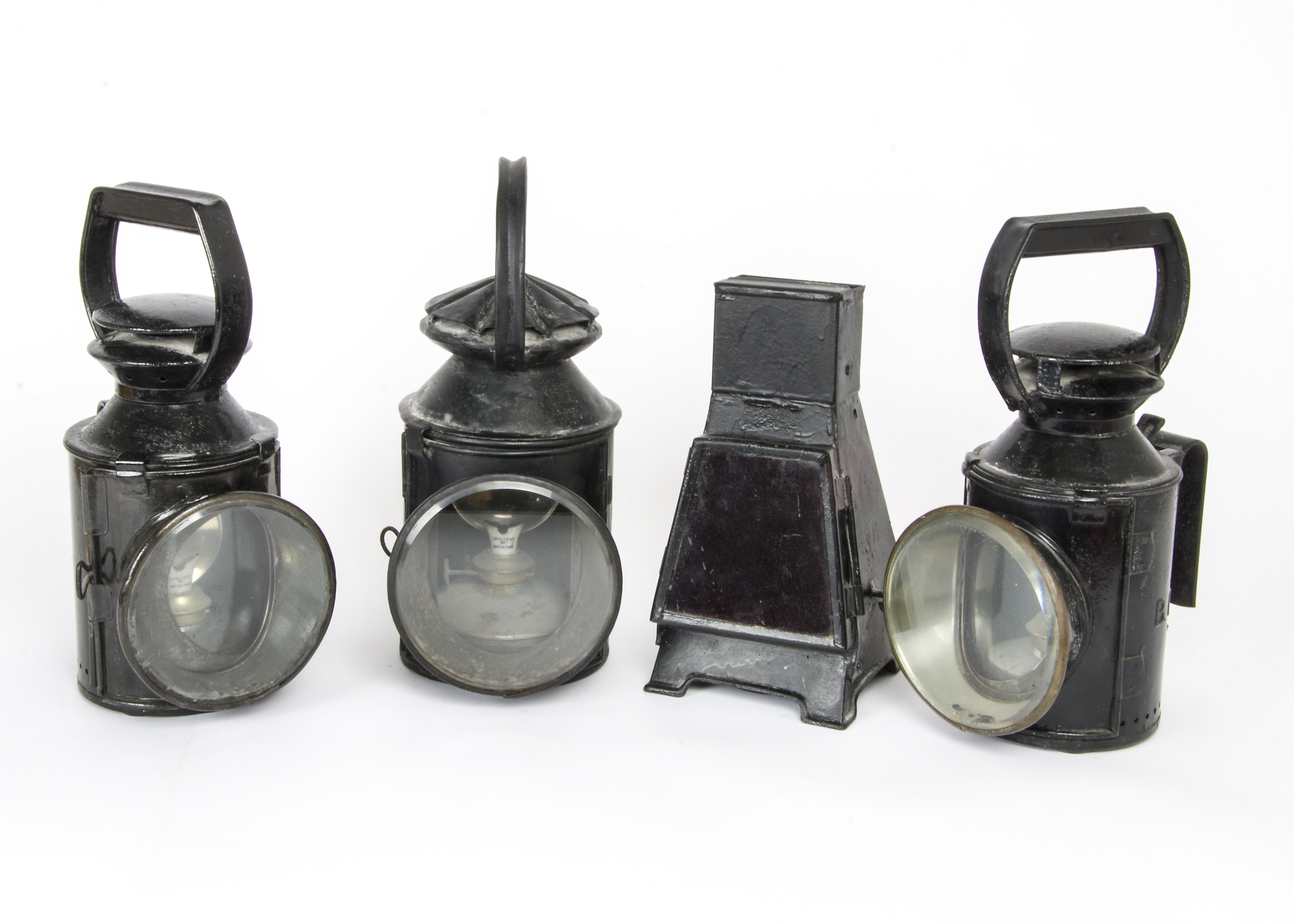 Railway Signal Lamps, a group of four black painted lamps, including three cylindrical examples, two