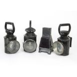 Railway Signal Lamps, a group of four black painted lamps, including three cylindrical examples, two