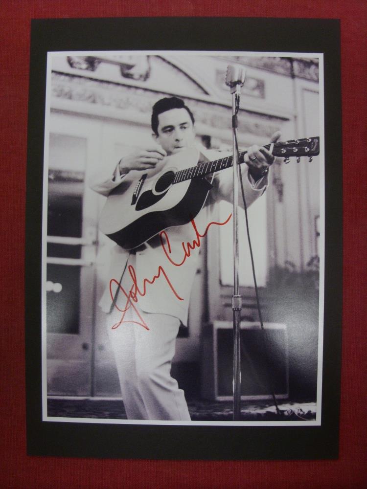 Pop Music, Johnny Cash, an autographed black/white photograph of Johnny, signed in red ink, the