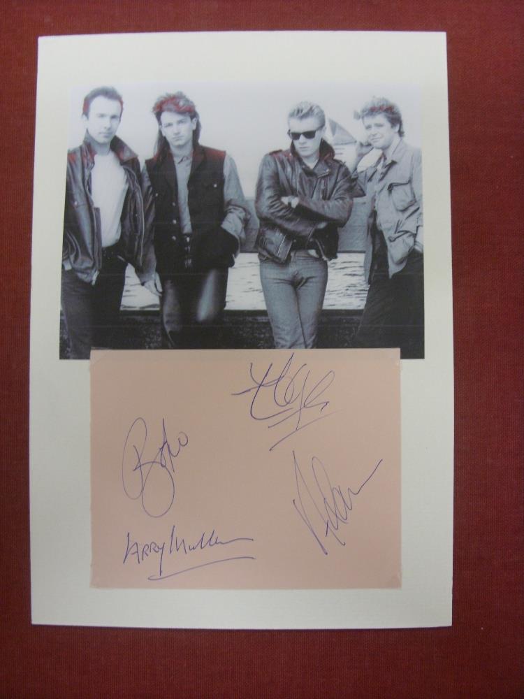 Pop Music, U2, a signed, white board mounted display, showing 4 autographs, of the 4 group