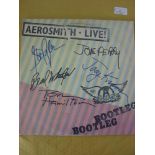 Pop Music, an autographed LP Record, by Aerosmith, The 1978 Album, Live! Bootleg, is signed on the