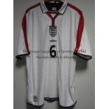 SOL CAMPBELL ENGLAND SHIRT A non-reversible white short sleeve shirt with red trimmings player issue