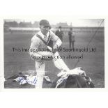 HAROLD LARWOOD / CRICKET AUTOGRAPH A signed b/w postcard showing Larwood getting his pads on. Good