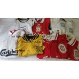 LIVERPOOL SHIRTS Eight replica short sleeve shirts with sponsor Carlsberg, from the 1990's. 3 red, 1