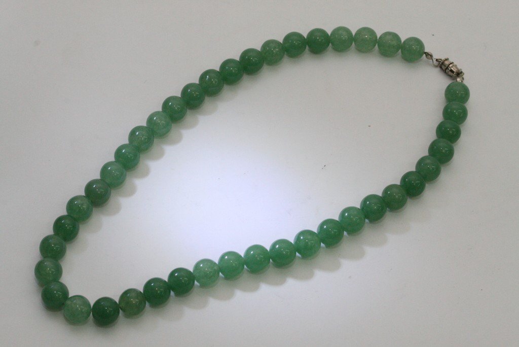 A jade choker necklace with white metal clasp.