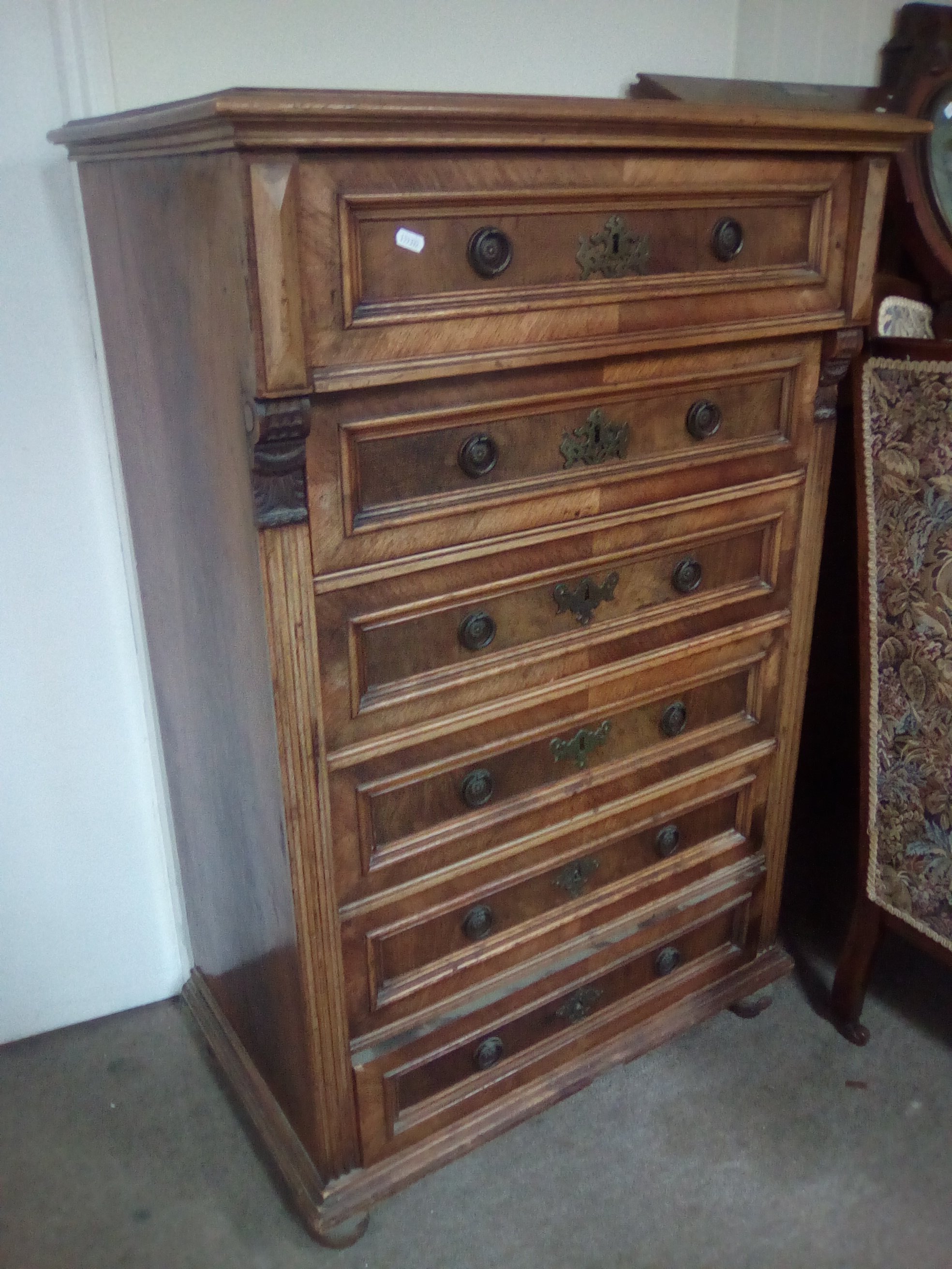 A continental walnut chest of drawers fitted with