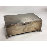 A silver cigarette box with engine turned decorati