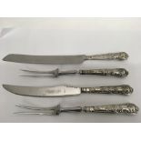 Four silver handled carving knives and forks, matc