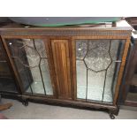 A mahogany two door glazed display cabinet raised