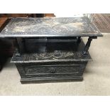 A oak carved monks bench with lift up seat