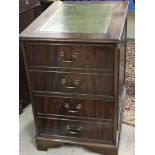 A pair of Mahogany filing cabinets with green leat