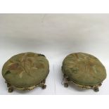 A pair of gilt wood footstools with embroidered to