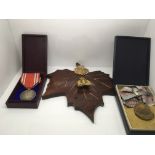 A collection of medals and badges to include a Jap