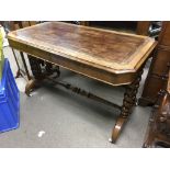 A Victorian walnut desk with inset leather octagon