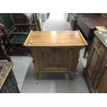 An oak cupboard with an open magazine rack on eith