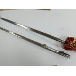 A Brass basket cased sword with red fabric padding