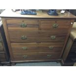 An Edwardian walnut chest of drawers fitted with t