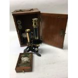 A mahogany cased microscope.