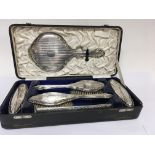 A cased lady’s silver dressing table set comprisin