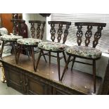 An Ercol dark wood dining table and four matchng c