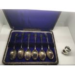 A cased set of silver teaspoons with football moti