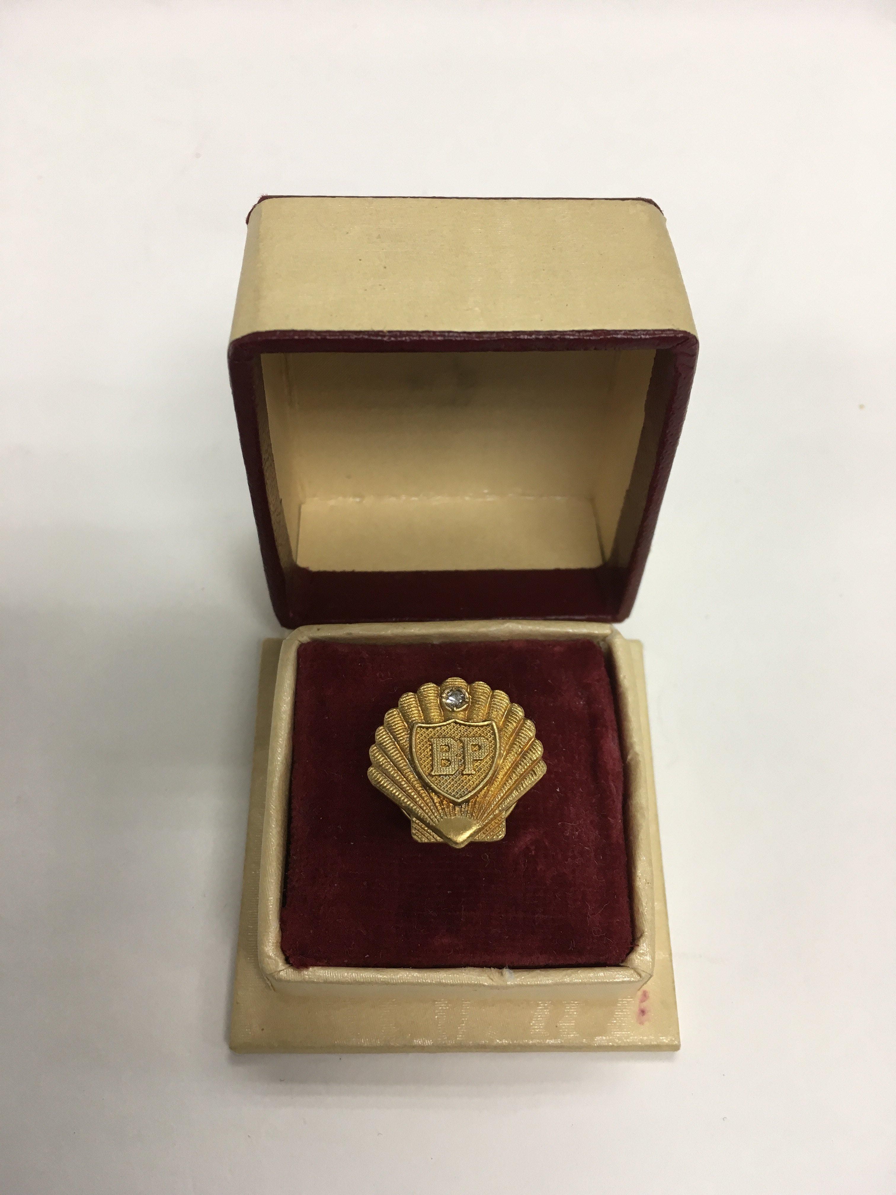 A 9ct gold BP pin badge for long service.