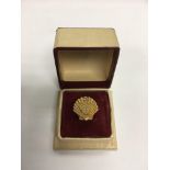 A 9ct gold BP pin badge for long service.