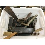 A box of old tools including a plane