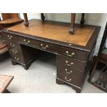 A large leather topped mahogany desk, approx 152cm