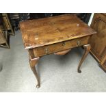 A walnut side table fitted with one drawer and rai