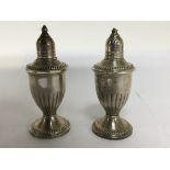 Two loaded silver condiments, with flutted sides,