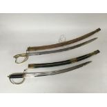 A pair of Indian cutlasses with scabbards.