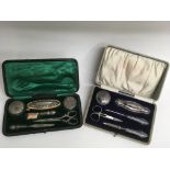 Two cased silver manicure sets