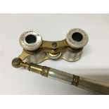 A pair of nice quality mother of pearl opera glasses, with a telescopic handle, made in France for