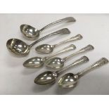 A set of five silver spoons and a pair of silver s