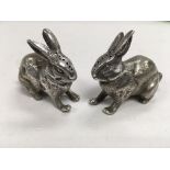 A pair of silver condiments in the form of rabbits