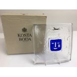 A boxed Kosta Boda glass slab ornament with face a