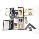 A bag contains a collection of Masonic Medals and aprons including Royal Masonic Institution for