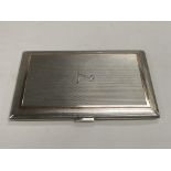 A silver cigarette case with engine turned decorat