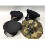 A bag containing a variety of military items including coats, shirts and hats.