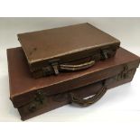 Two vintage leather suitcases.