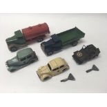 A collection of 5 unboxed Minic model vehicles including a petrol tanker and a tipper lorry.