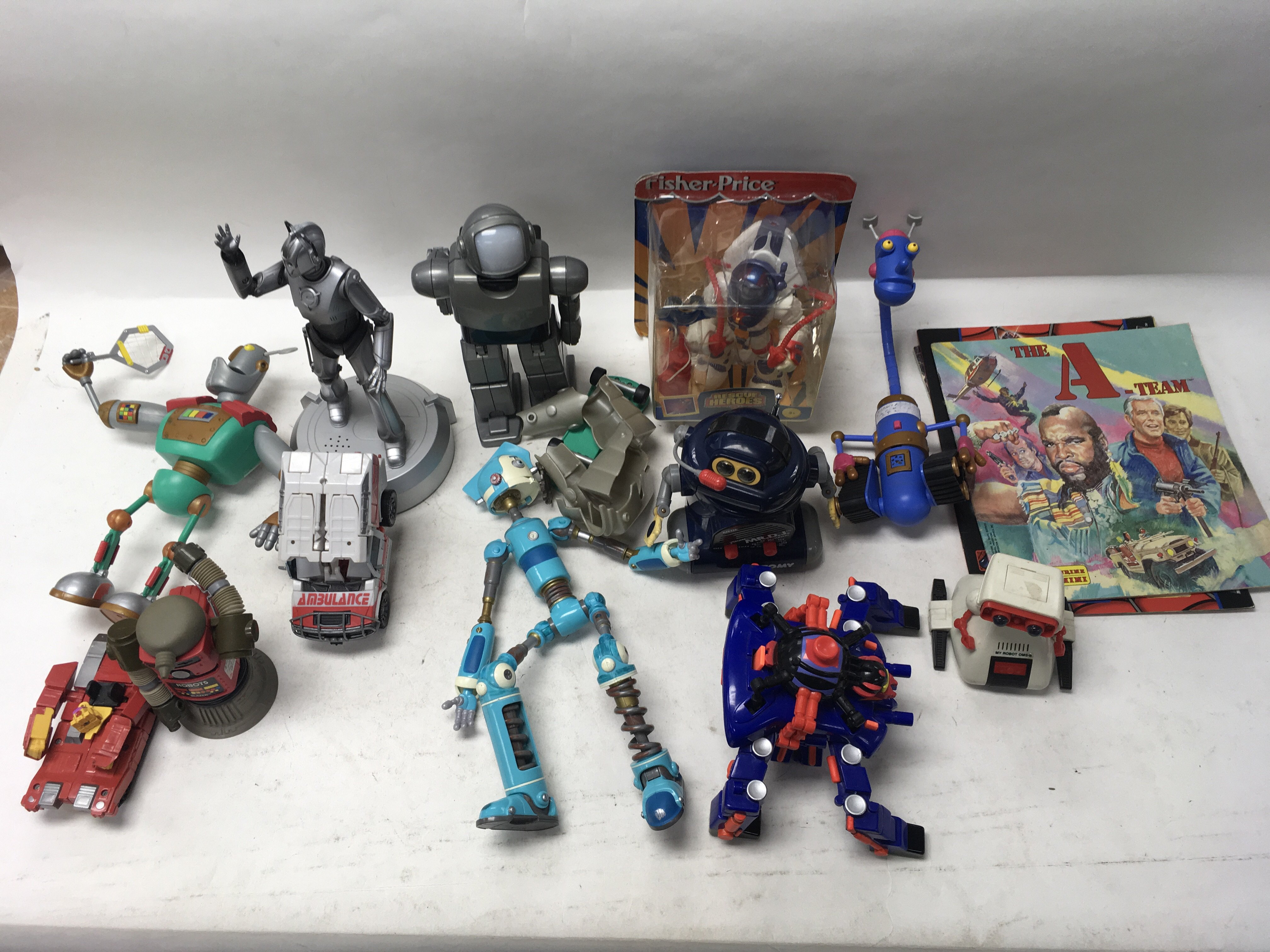 A collection of various robot toys including Tomy.