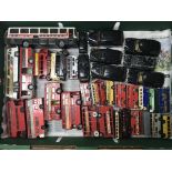 A box of unboxed model buses and taxis and a box of unboxed fire engines.