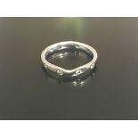 An 18ct white gold wedding band with diamonds. Wei