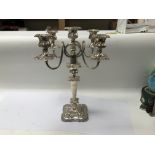 A silver plated candelabra with ornate design