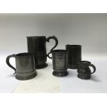 An antique Pewter quart measure jug and four pewte