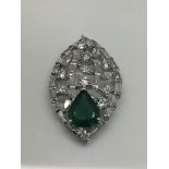 A 14ct white gold, diamond and emerald pendant, em