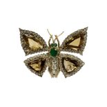 A fine diamond and emerald brooch in the form of a
